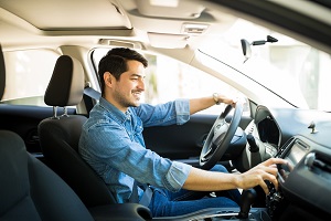 Man switching radio station while driving